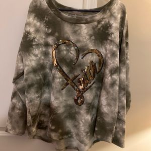 Tie-Dye army green sweatshirt with sequin heart that spells out “faith”.